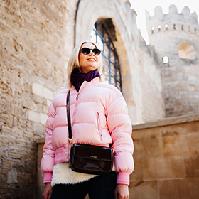 Woman in a pink jacket on a Baku photo tour in the Old Town