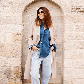 Portrait of woman standing in stone archway in Icherisheher Old City Baku